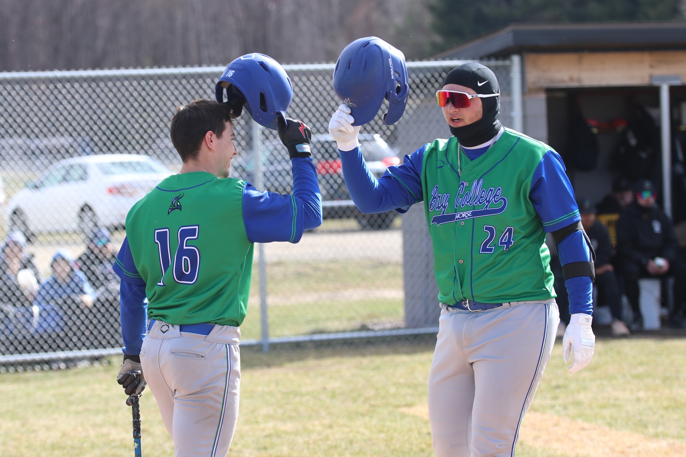 Austin Samanske is greeted at the plate by Shane Lievsay after Samanske's two-run home run