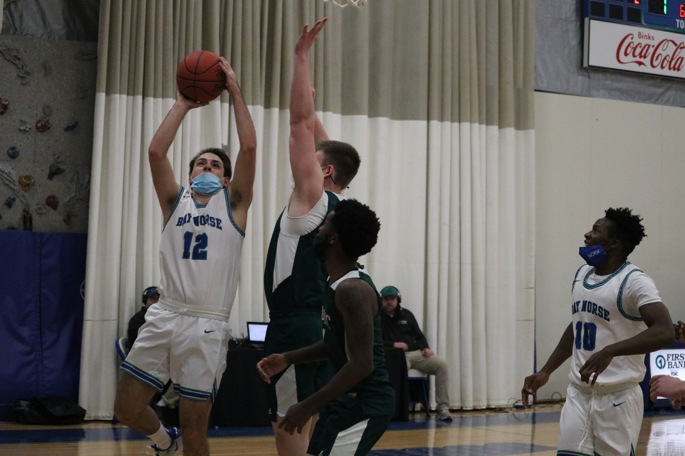 Matt Wagner going up for a layup with a defender with outstretched hands next to him