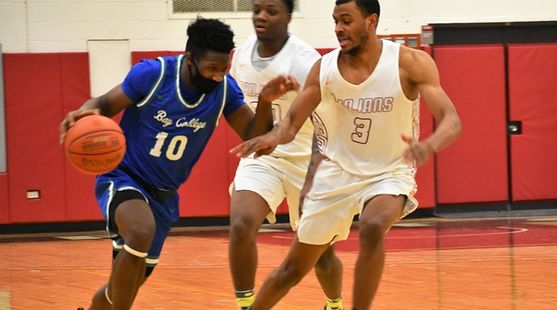 Chris Dobessi tries to dribble past two defenders