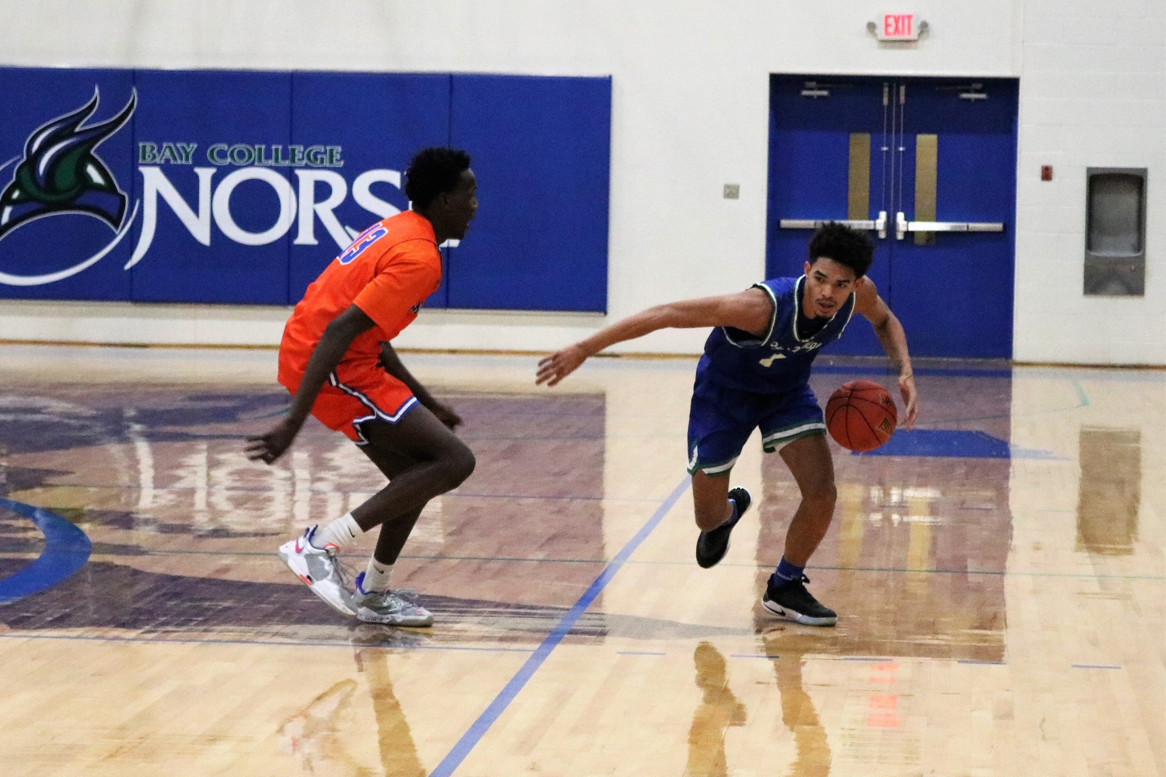 Joc Overstreet dribbling past his defender out near half court
