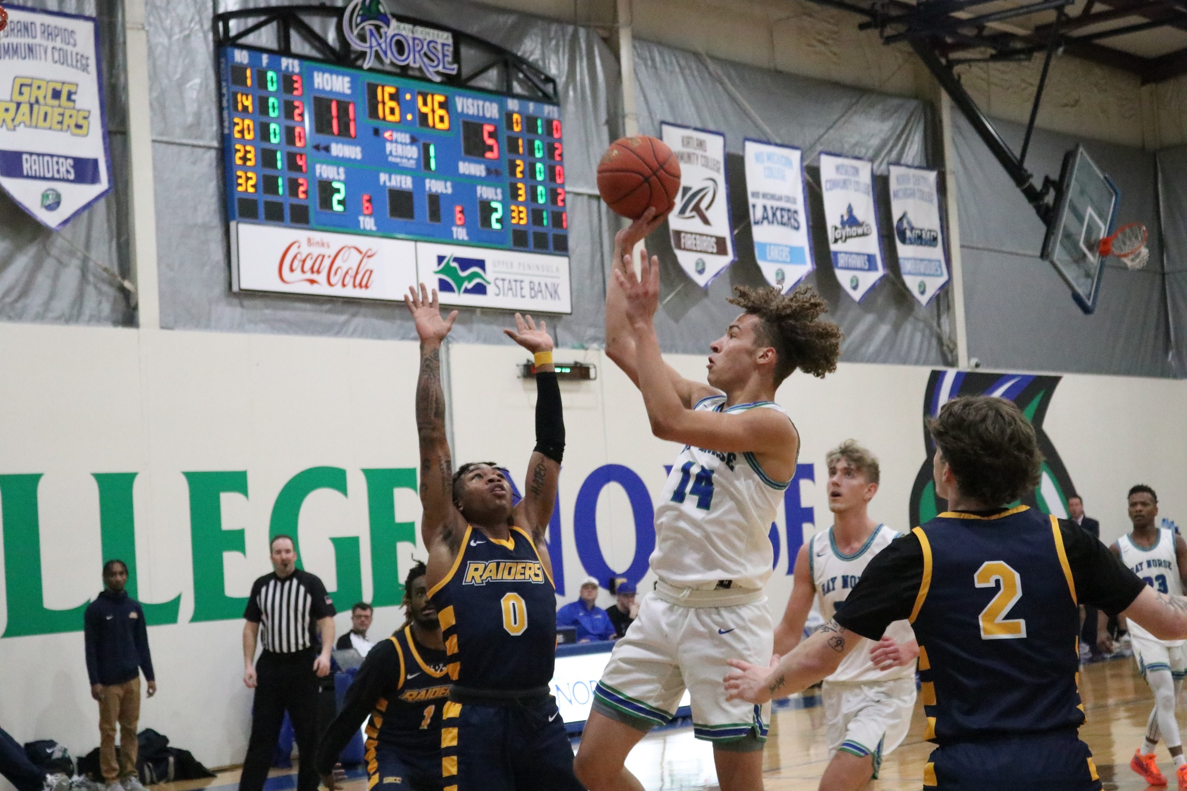 Tyrel Creger about to release a one-handed shot as a defender reaches up