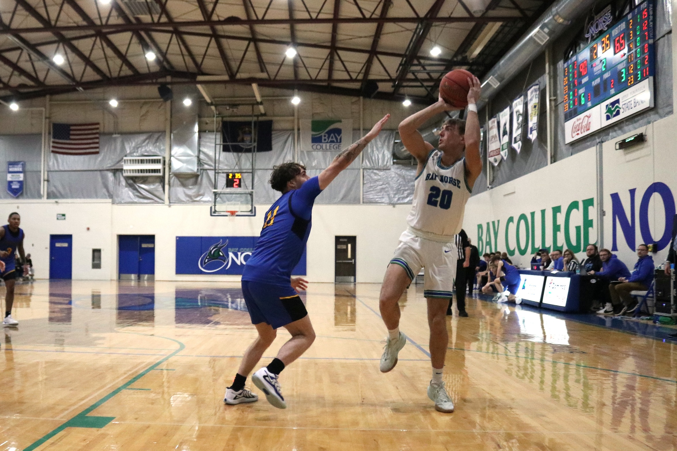 Dylan Plunger lifts off of one foot to shoot as a defender closes in