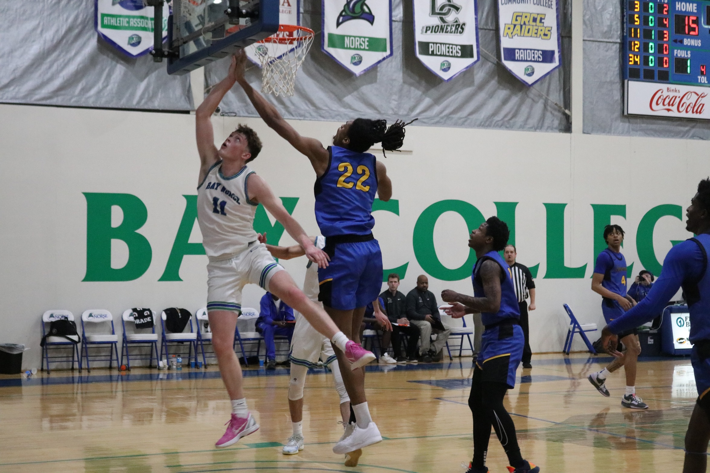 Emerson Droubie looks up at a recent layup attempt as a defender reaches to try and block it
