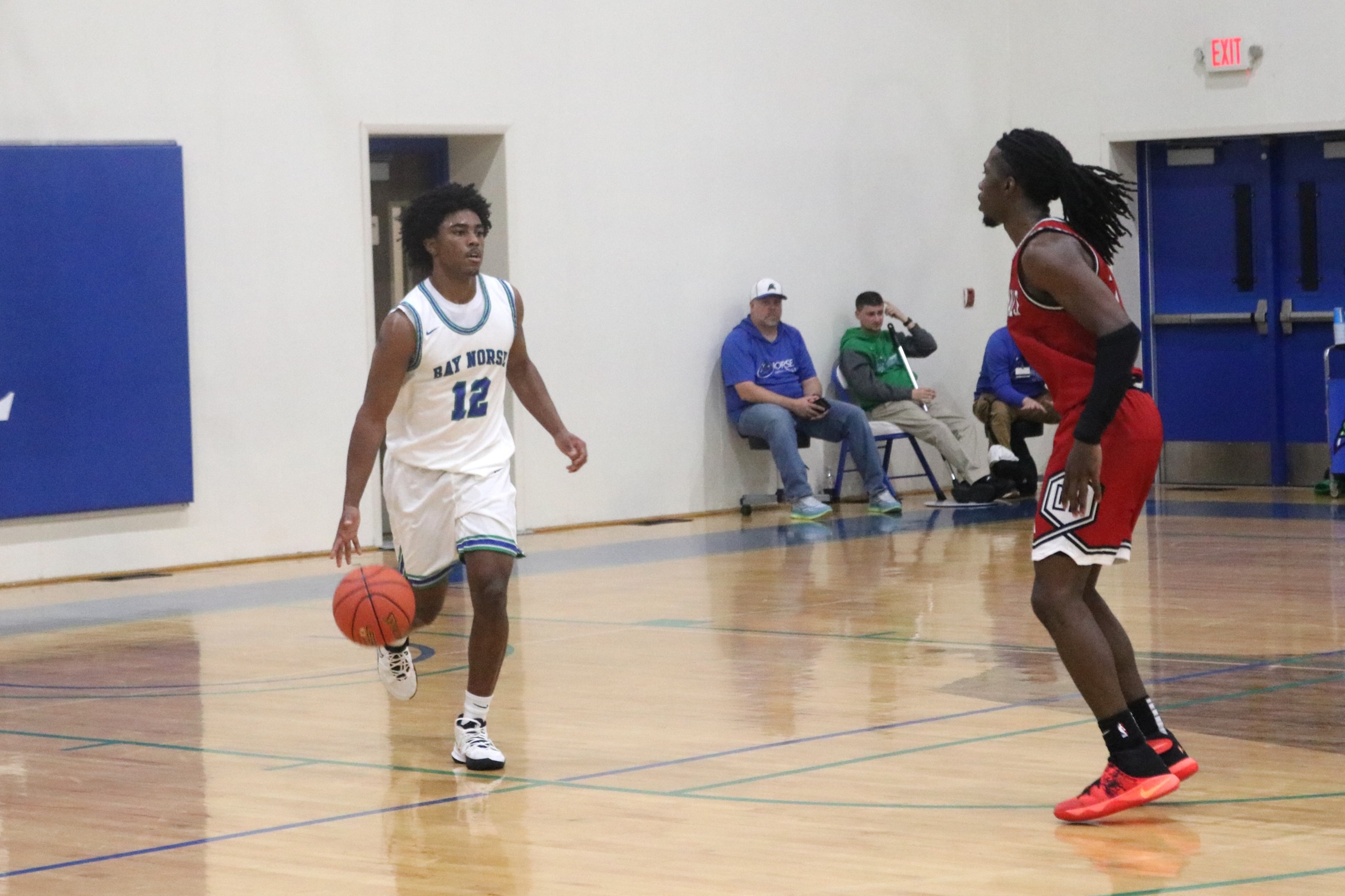 Trey Frye III dribbles the ball in the back court as a defender looks on