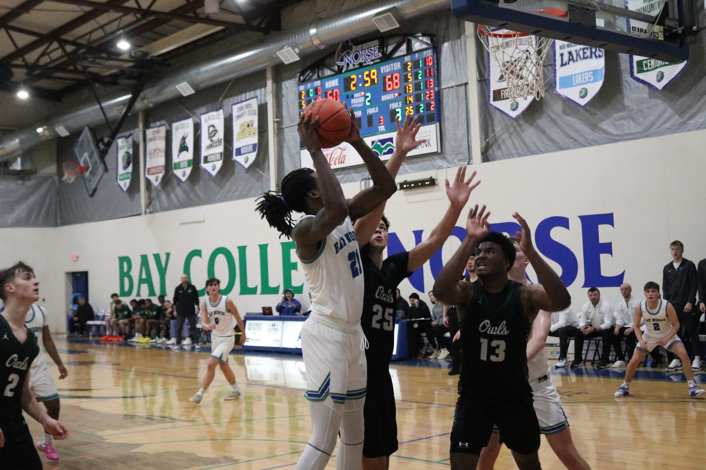 Taveon Vann goes up for a shot with two defenders closing in
