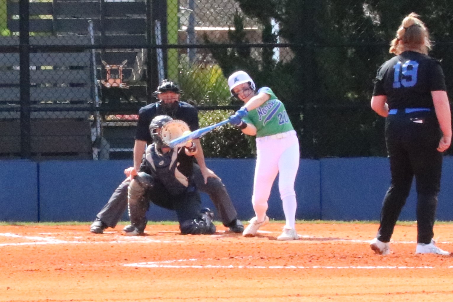 Ellie Miller making contact with a pitch at the plate