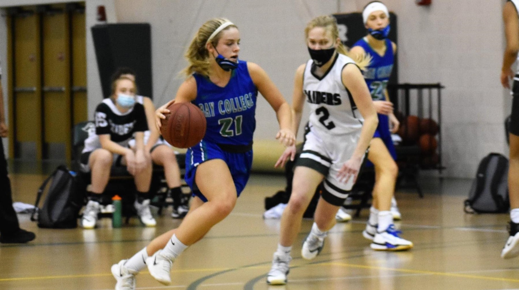 Brooke Mannor dribbles to her right, a defender chases her