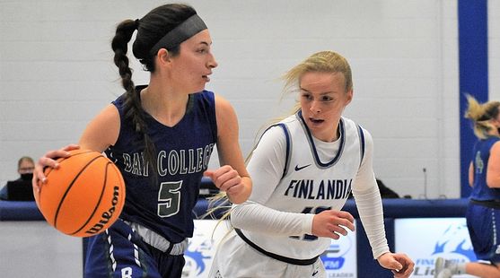 Kennedy Englund dribbles to her right with a defender closely guarding