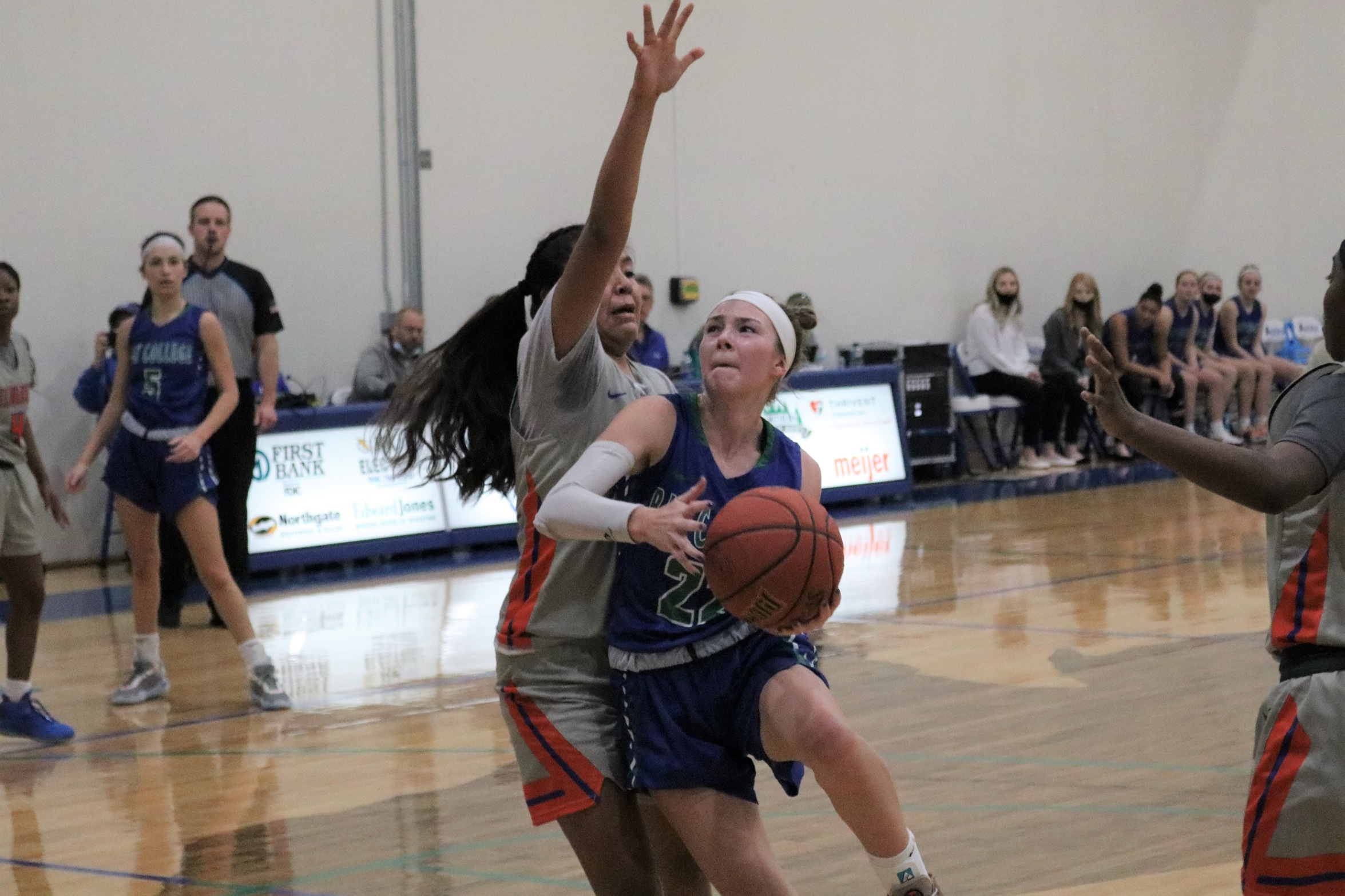 Cheveney Koski fighting through contact as she puts a shot up in the lane