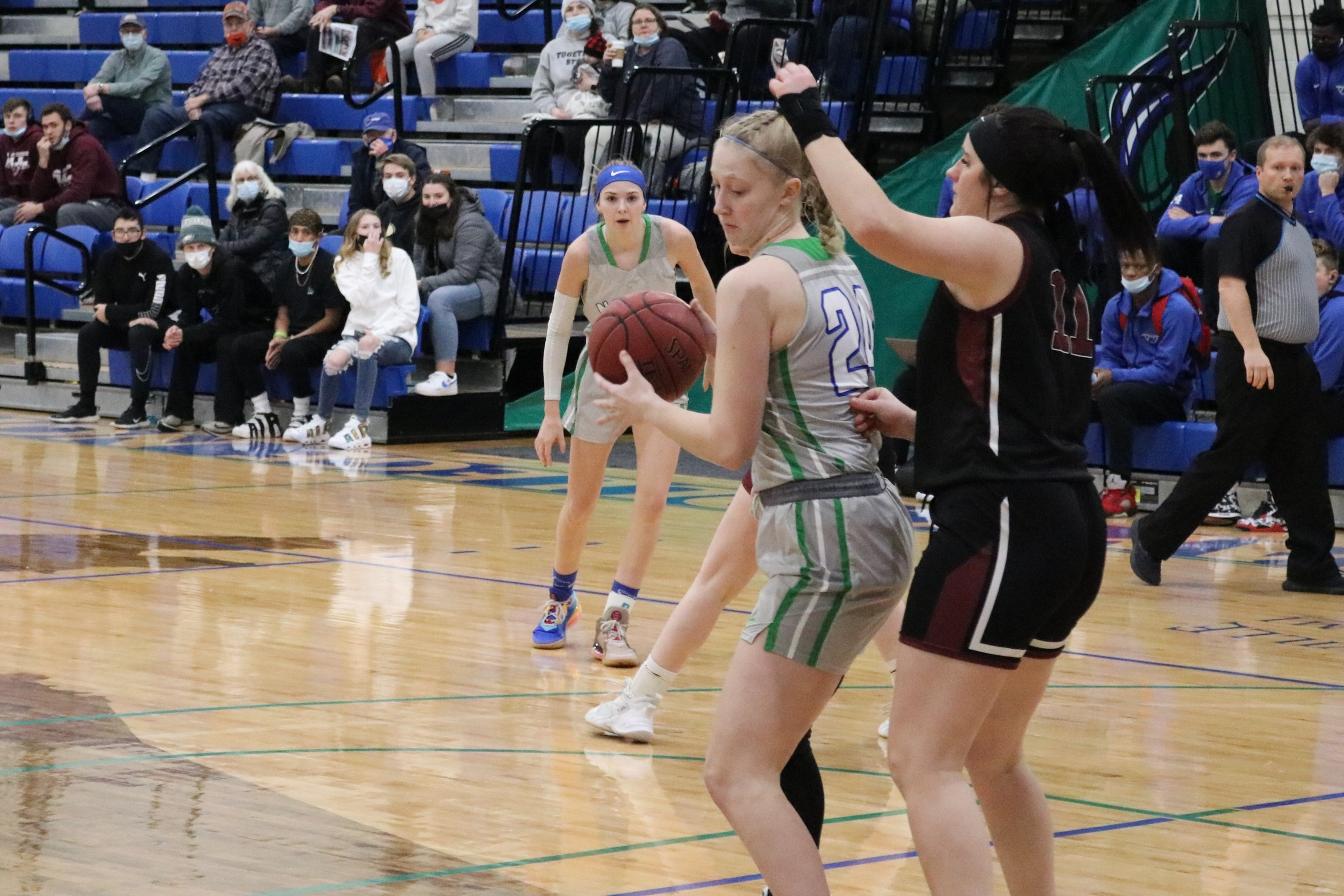 Madison Olsen with the ball in the post, a defender on her back