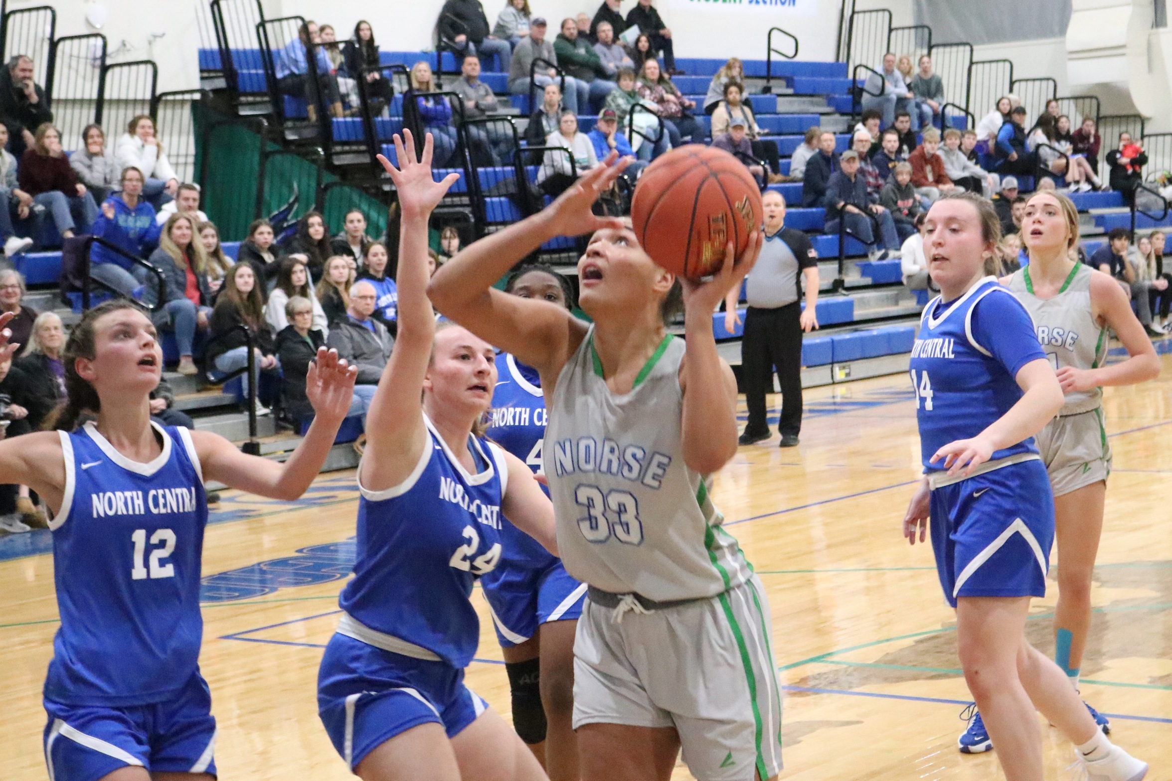 Tianna Taylor going up for a layup that would put the game out of reach as defenders close in on her