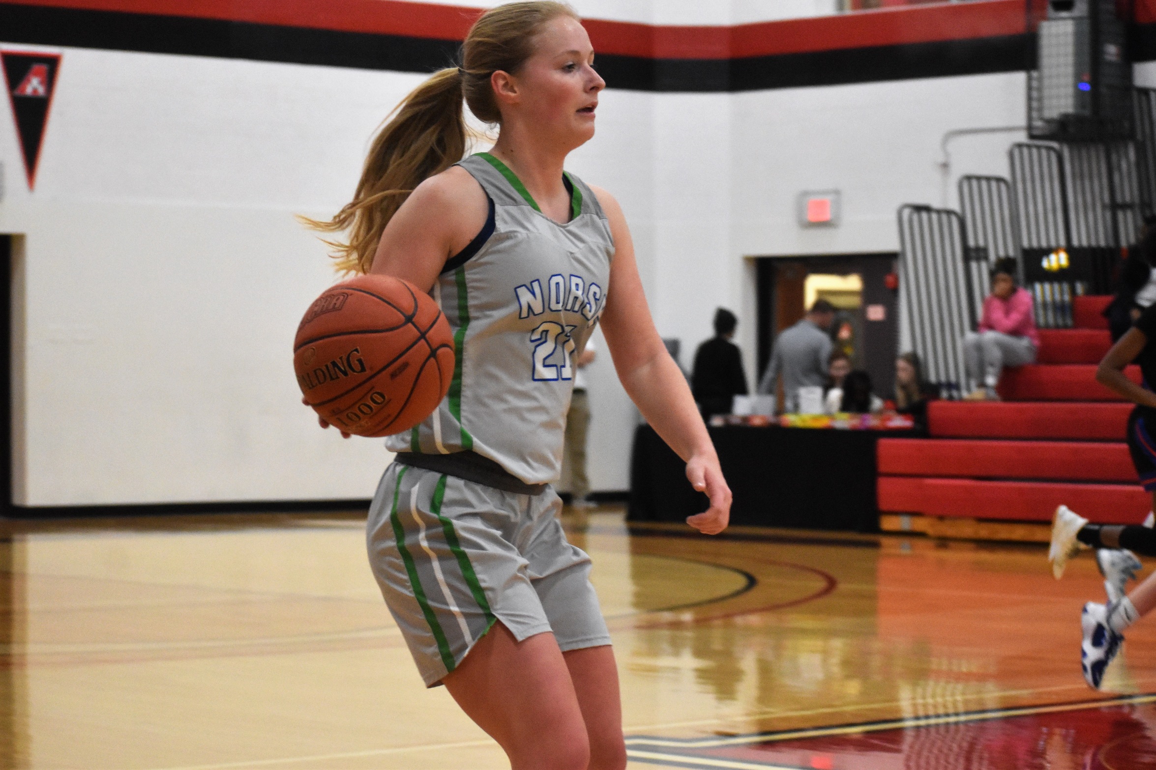Aliana Trudeau dribbles the ball up the court