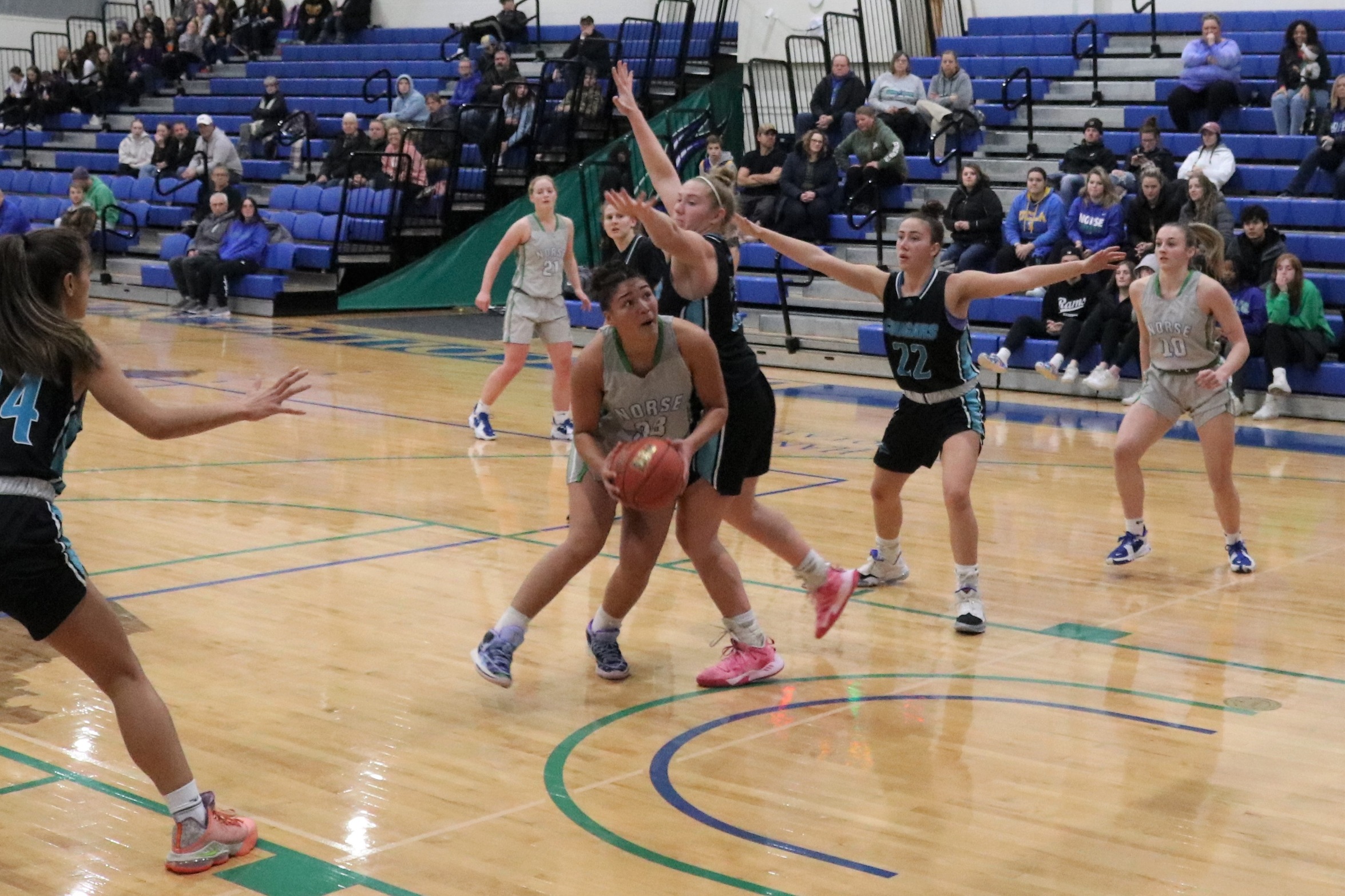 Tianna Taylor ducks under the defender's outstretched arm as she spins toward the basket looking for a shot