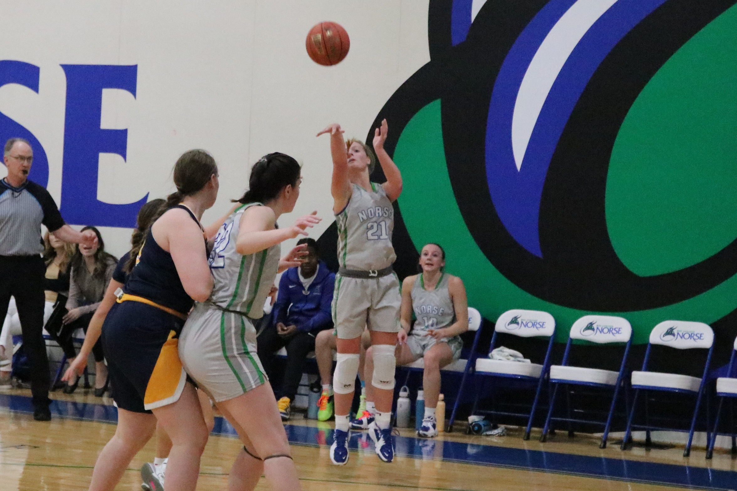 Alaina Trudeau releases a three in front of the Bay bench
