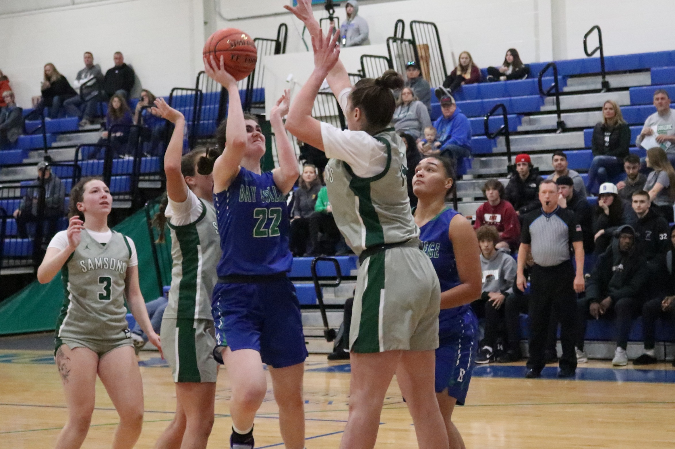 Kassidy Roll about to shoot in the lane, a defender reaching to try and block it