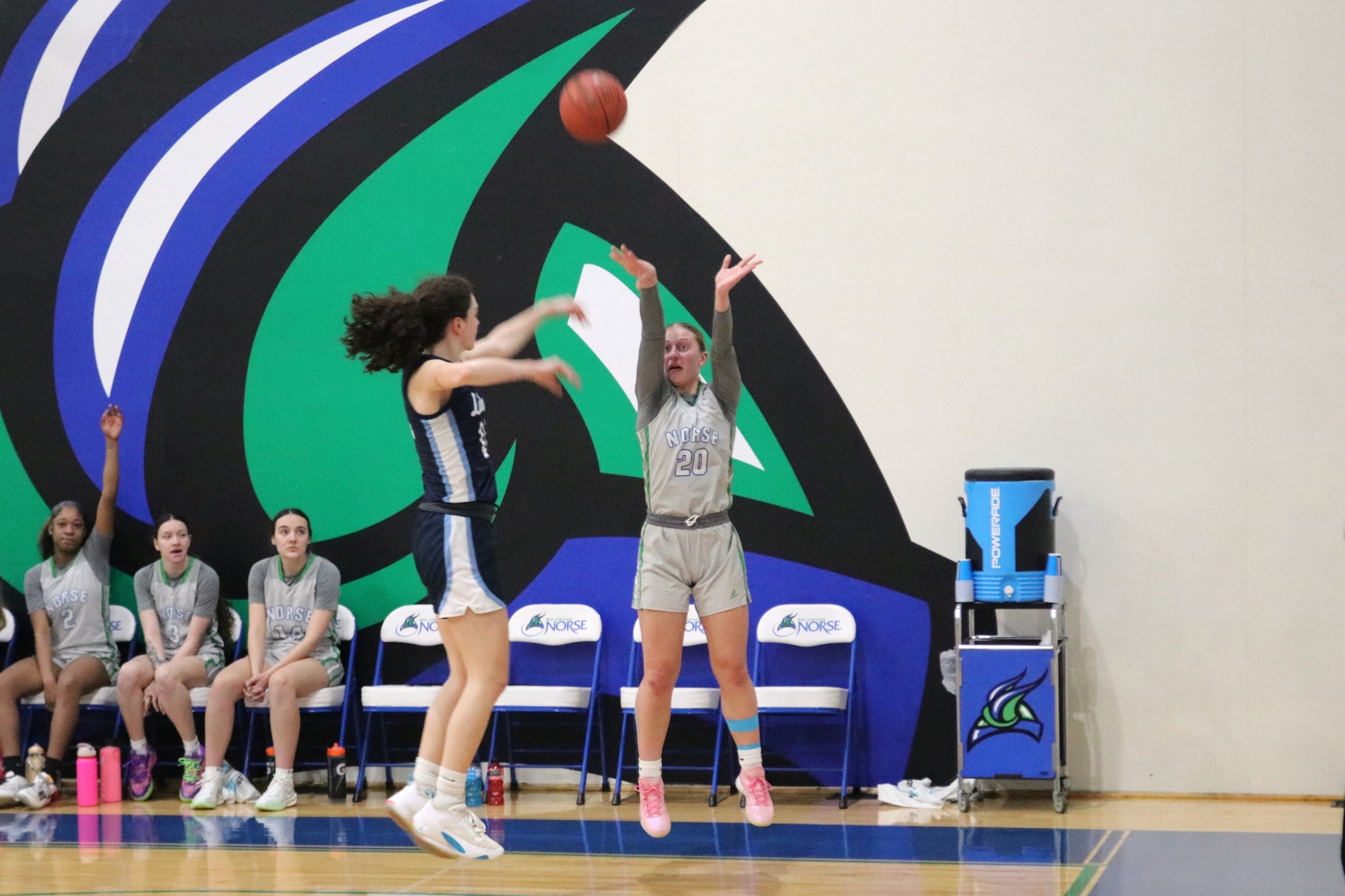 Emma Rutter releases a three in front of the Bay bench as a defender closes out