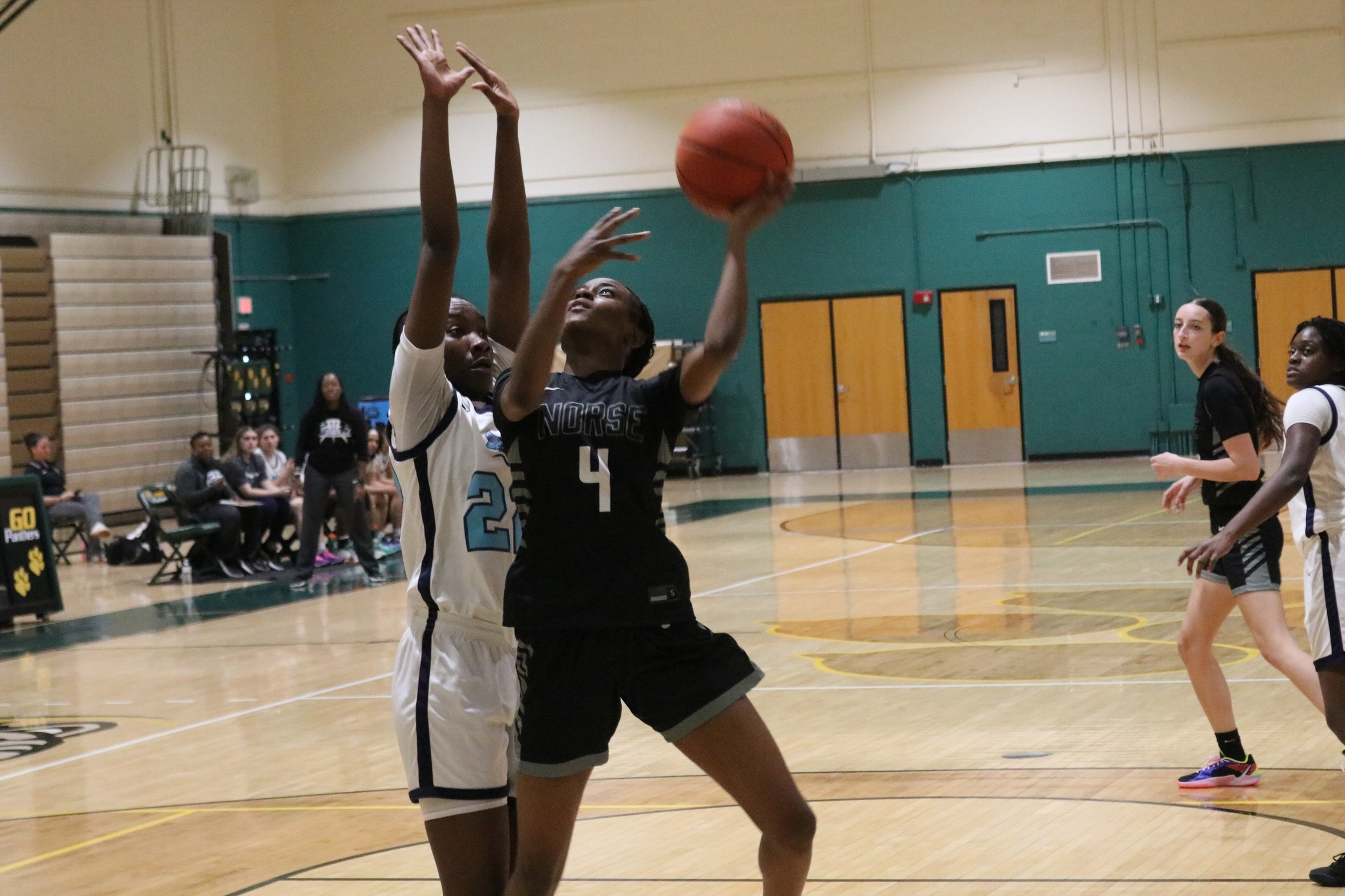 Anisa Longs going up for a shot with a defender close by