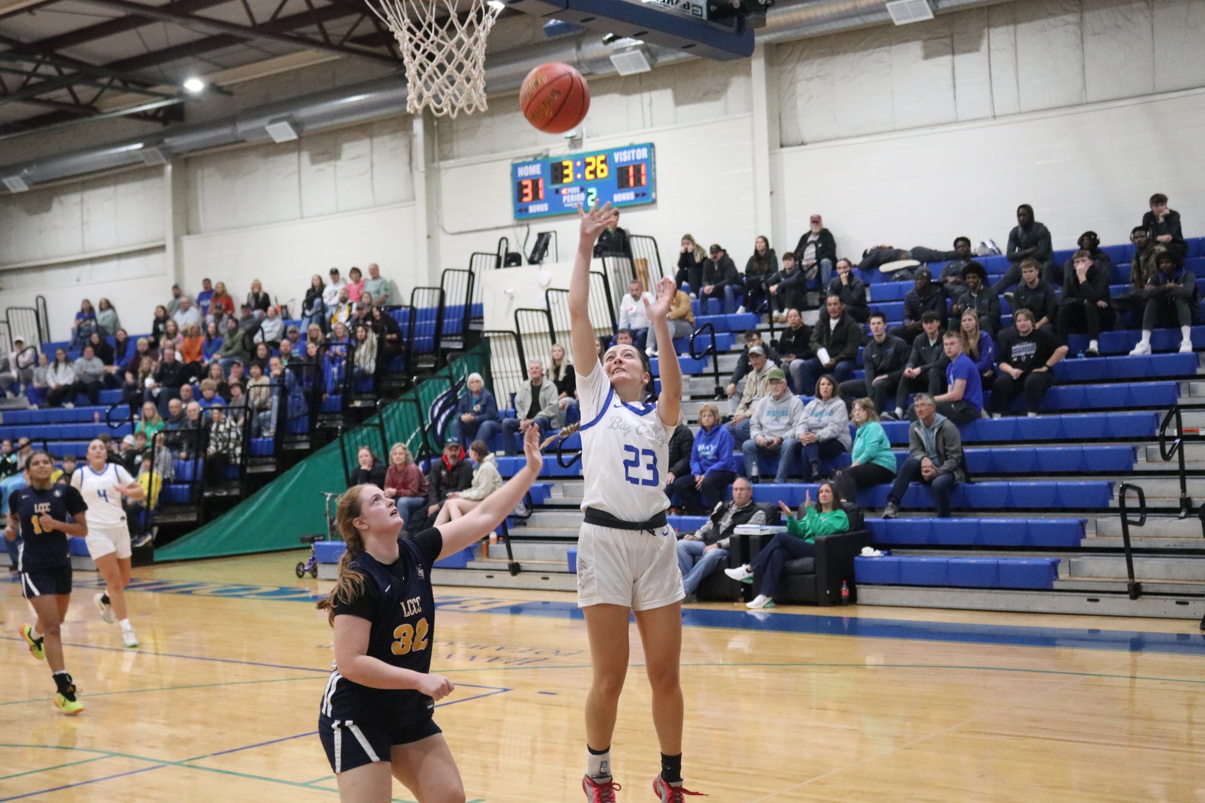 Mckenzie Hoffmeyer puts  up a layup as a defender closes in
