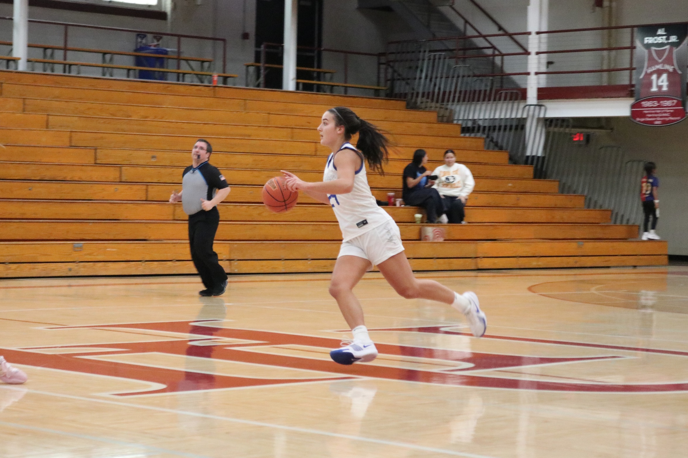 Lauren Zawada dribbles the ball across half court.