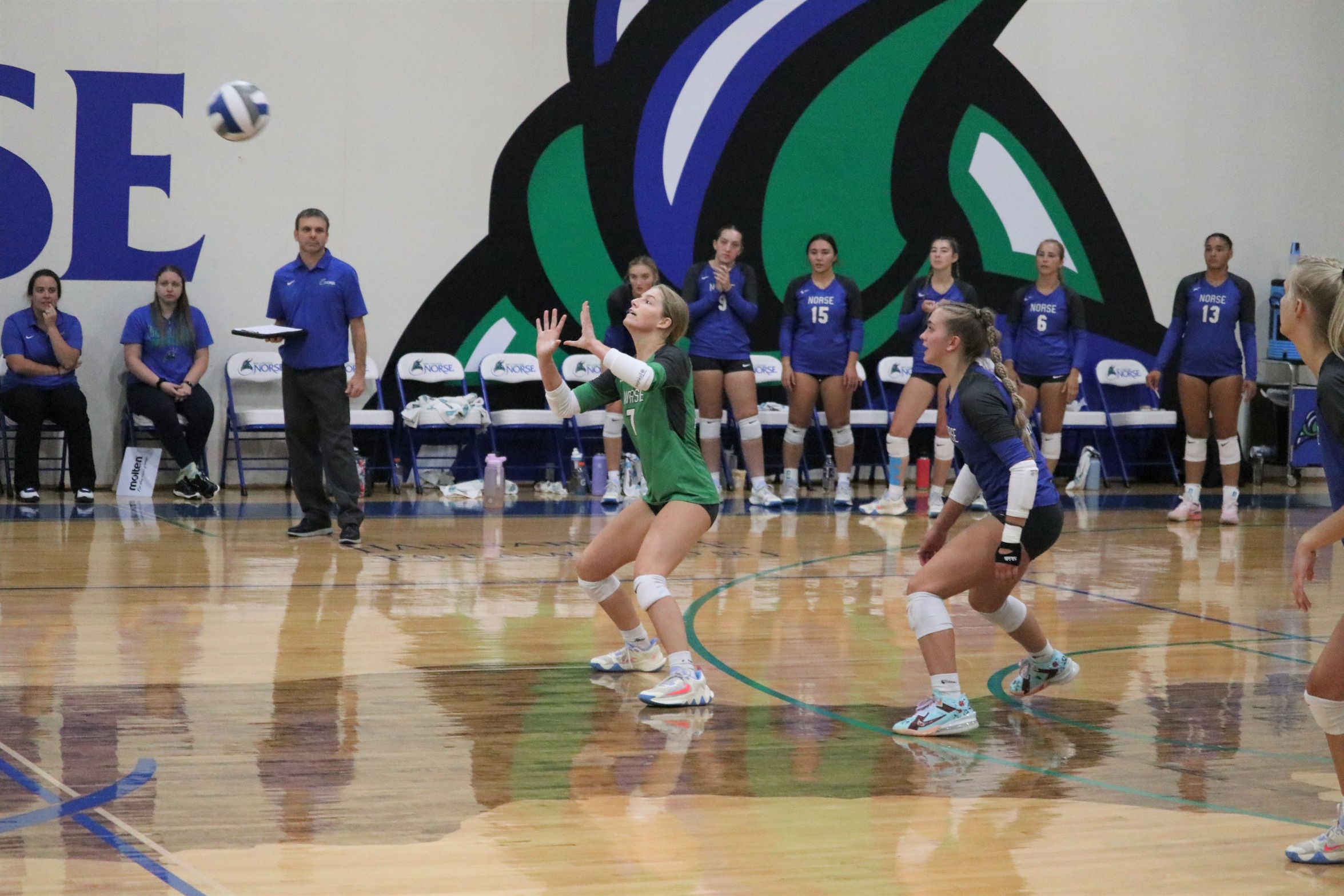 Tori Jandt ready to play a ball in game action as her teammates look on